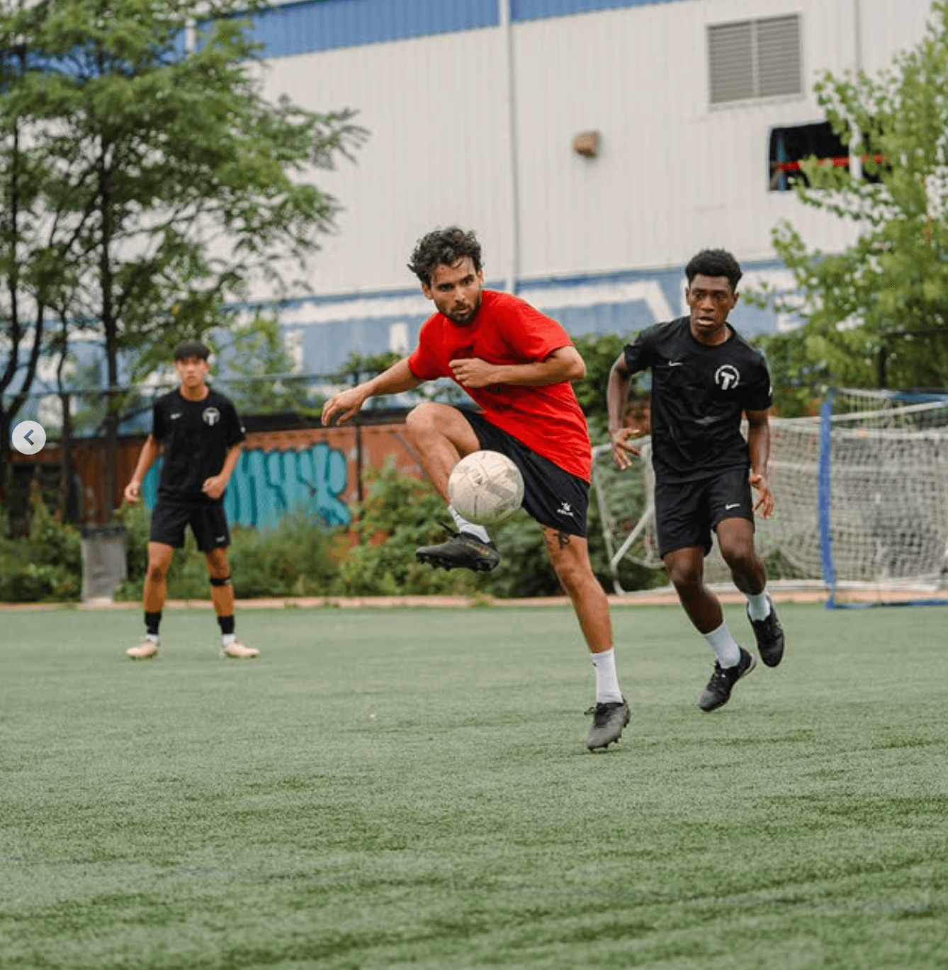 Players chasing the ball during a SoccerMates match
