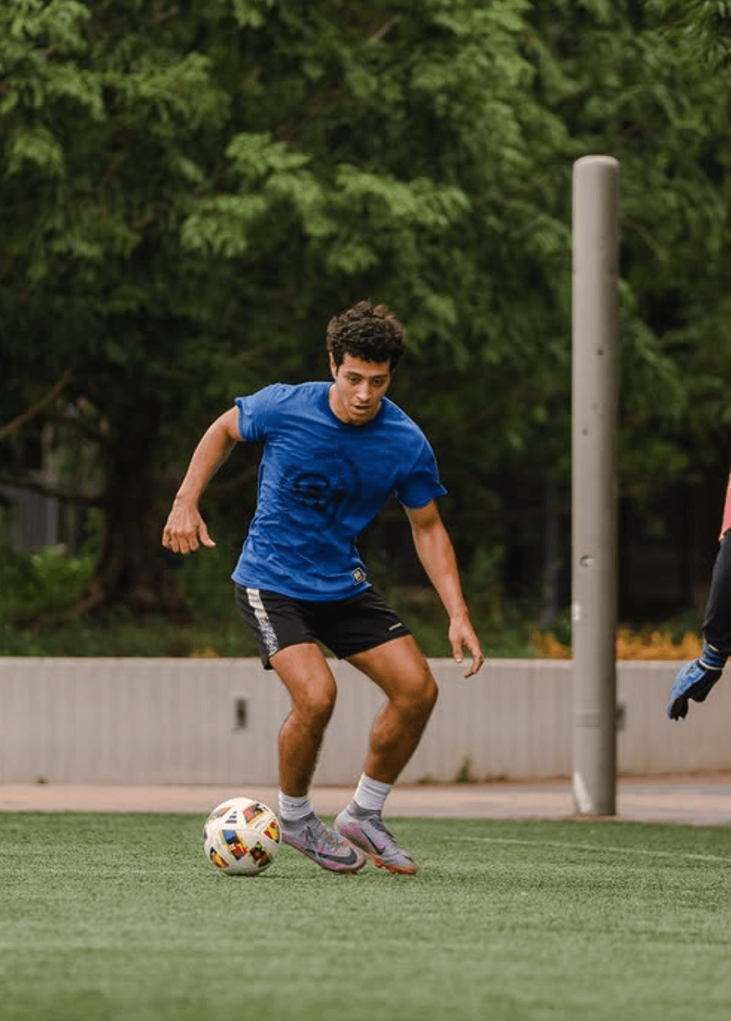 A SoccerMates player dribbling on the turf